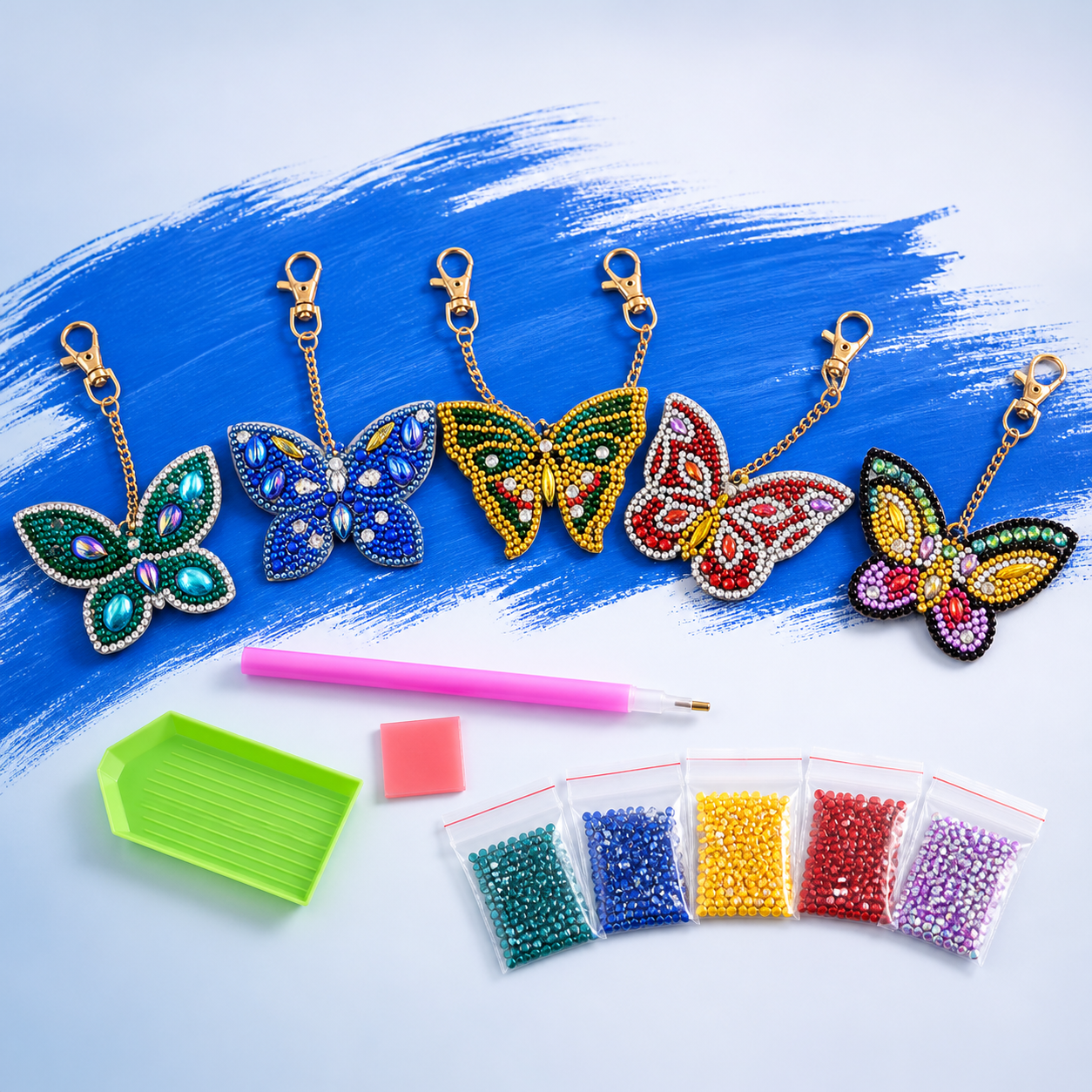 Complete set met vijf vlindersleutelhangers, steentjes en gereedschap